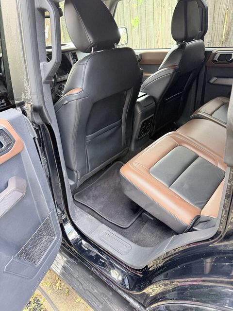 Driver seat of a Ford Bronco from the open door, sill and seat base clean