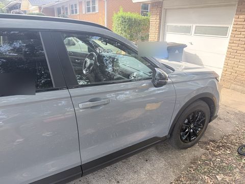 A grey Honda CR-V parked clean in a North Austin driveway