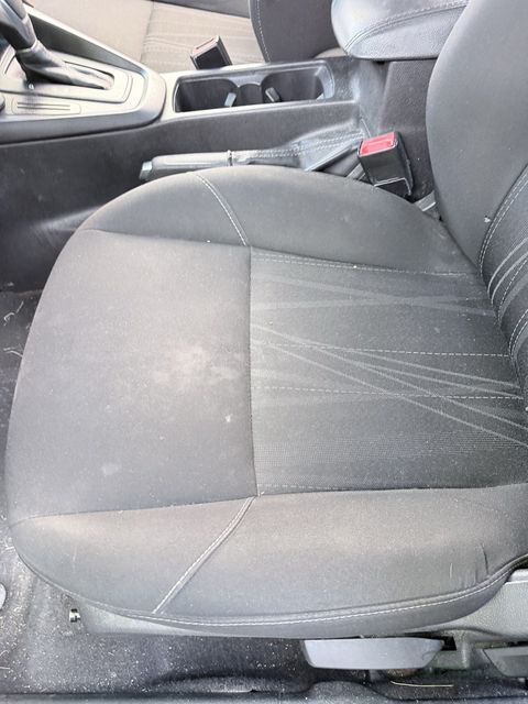 Cloth driver seat of a Ford Focus before cleaning, soiled and marked